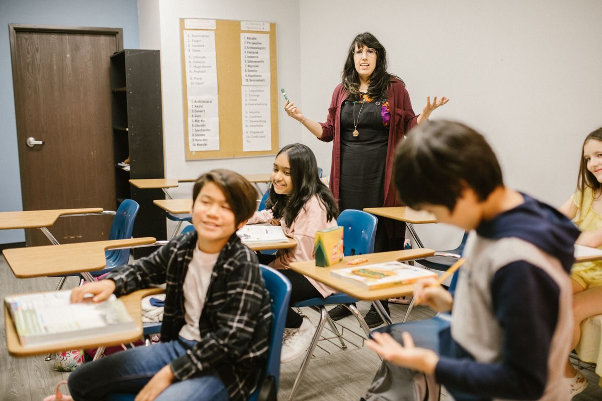 A teacher leading a lively, mixed secondary school class